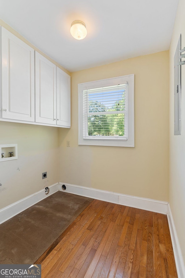 2055 Cactus Ln, Cumming, GA 30040 - laundry area featuring cabinet space, hookup for a washing machine, light wood finished floors, and hookup for an electric dryer