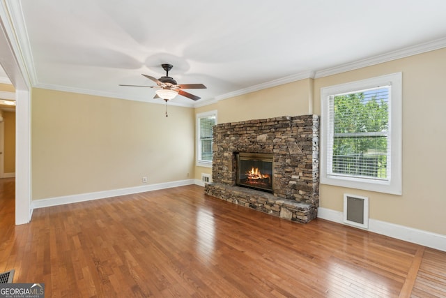 2055 Cactus Ln, Cumming, GA 30040 - unfurnished living room with a stone fireplace, wood finished floors, ceiling fan, and ornamental molding
