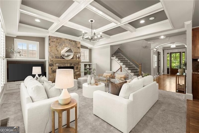 1286 Whisper Cove Dr, Buford, GA 30518 - living room featuring crown molding, coffered ceiling, stairway, wood finished floors, and a chandelier