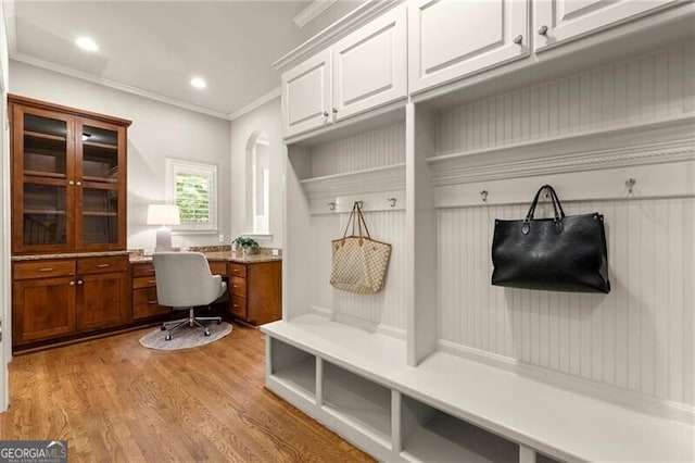 1286 Whisper Cove Dr, Buford, GA 30518 - mudroom with built in desk, ornamental molding, light wood-type flooring, and recessed lighting