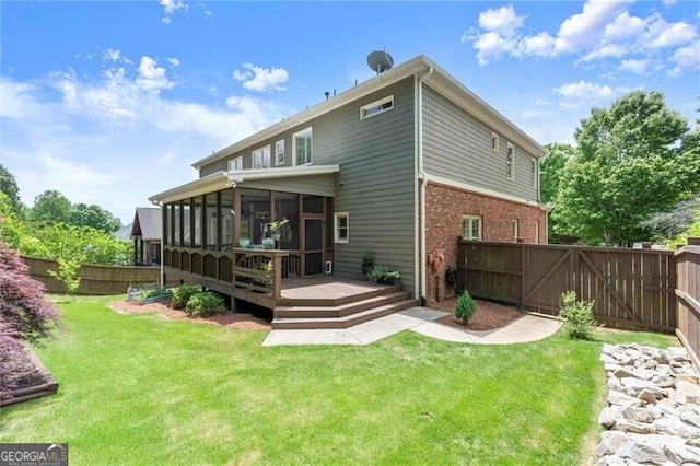 1286 Whisper Cove Dr, Buford, GA 30518 - back of house with a sunroom, a fenced backyard, a deck, and brick siding