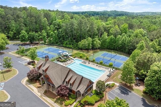1286 Whisper Cove Dr, Buford, GA 30518 - drone / aerial view of a heavily wooded area and a pool area