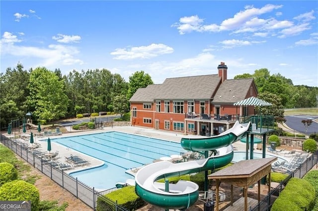 1286 Whisper Cove Dr, Buford, GA 30518 - community pool with a water slide, a patio area, and view of wooded area