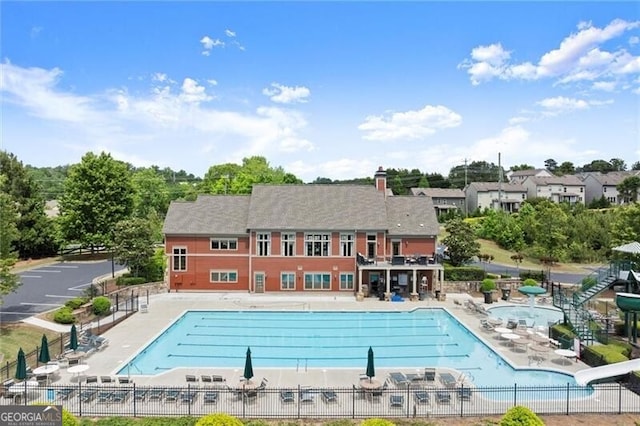 1286 Whisper Cove Dr, Buford, GA 30518 - community pool featuring a water slide and a patio area