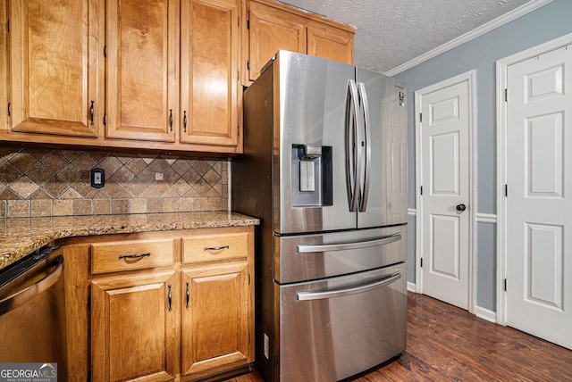 1235 Waterwood Dr, Loganville, GA 30052 - kitchen featuring appliances with stainless steel finishes, decorative backsplash, dark wood-type flooring, ornamental molding, and light stone countertops