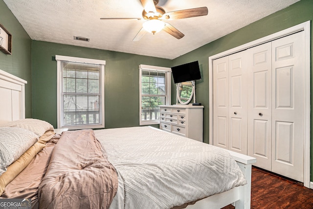 1235 Waterwood Dr, Loganville, GA 30052 - bedroom with a closet, dark wood finished floors, ceiling fan, and a textured ceiling
