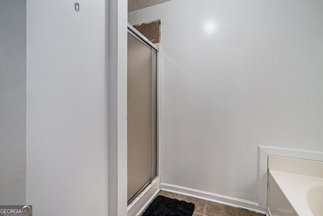 1235 Waterwood Dr, Loganville, GA 30052 - bathroom with a shower stall and tile patterned flooring
