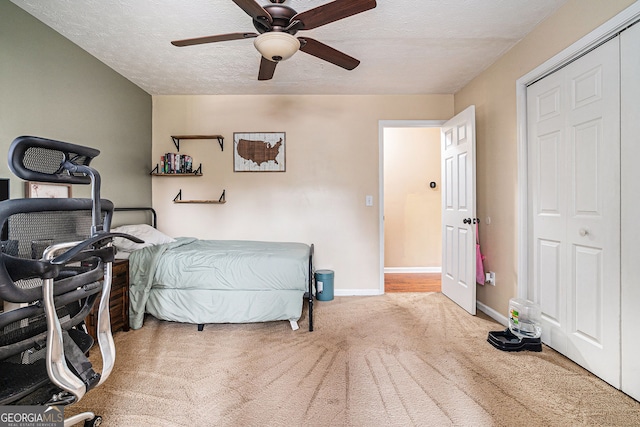 1235 Waterwood Dr, Loganville, GA 30052 - carpeted bedroom with a textured ceiling and ceiling fan