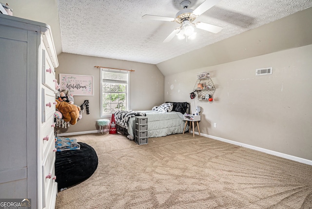 1235 Waterwood Dr, Loganville, GA 30052 - carpeted bedroom featuring vaulted ceiling, a textured ceiling, and a ceiling fan