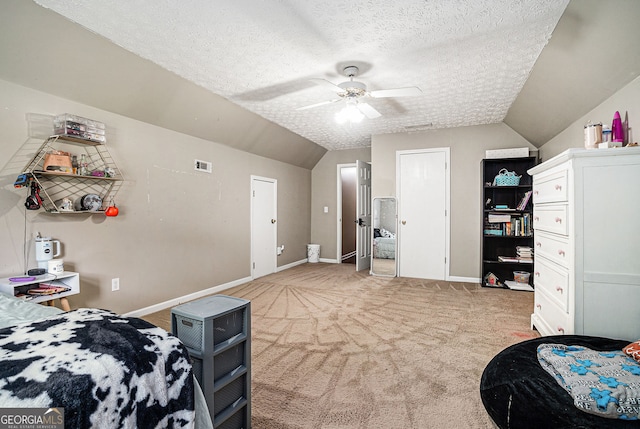 1235 Waterwood Dr, Loganville, GA 30052 - bedroom featuring light carpet, lofted ceiling, a textured ceiling, and ceiling fan