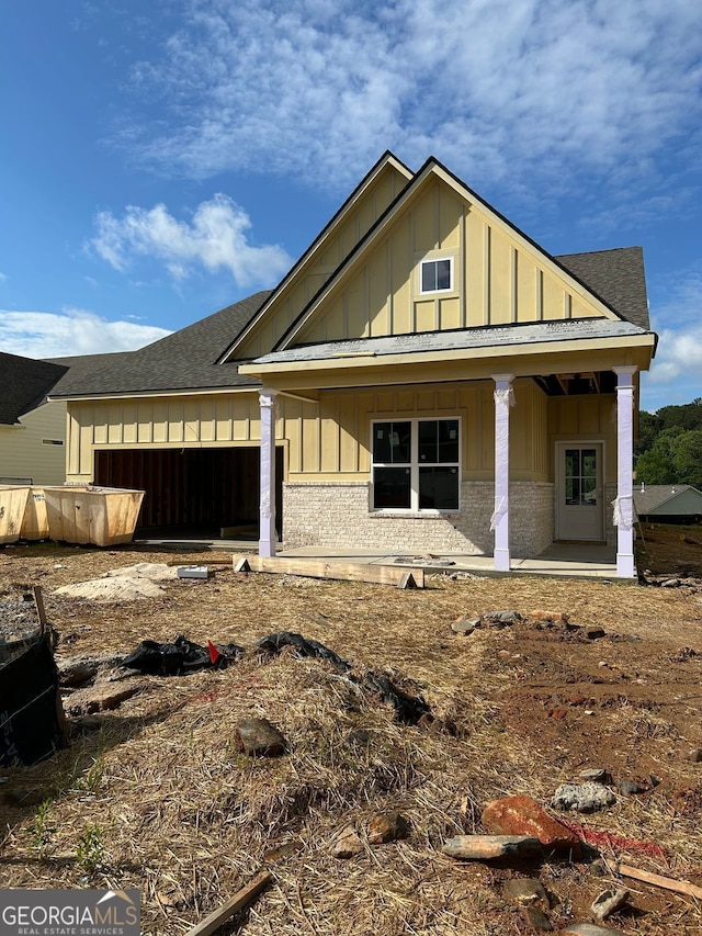 2004 Homestead Ct, Woodstock, GA 30189 - view of front of home with board and batten siding, roof with shingles, covered porch, and brick siding