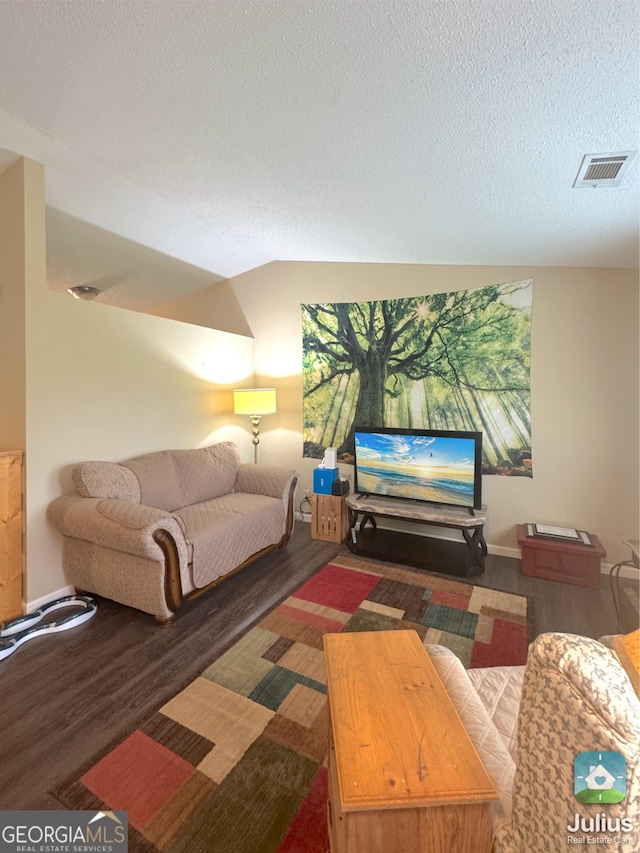 living area with wood finished floors and a textured ceiling