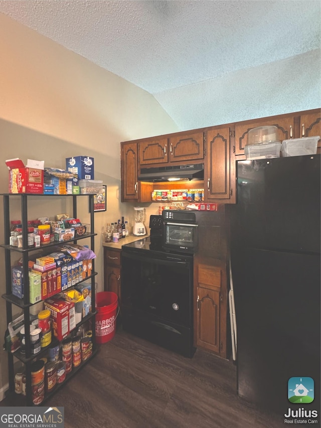 kitchen featuring freestanding refrigerator, dark wood finished floors, washer / dryer, a textured ceiling, and lofted ceiling