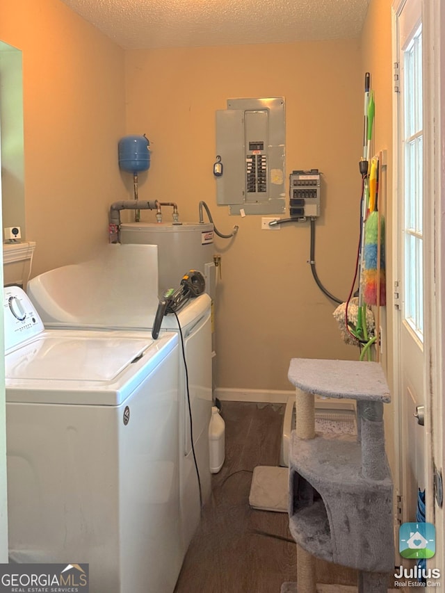 laundry room with electric panel, water heater, separate washer and dryer, and baseboards