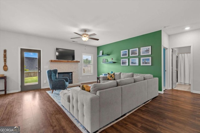 123 Cedar Park Way, Carrollton, GA 30117 - living room with dark wood-style flooring, ceiling fan, baseboards, a brick fireplace, and recessed lighting
