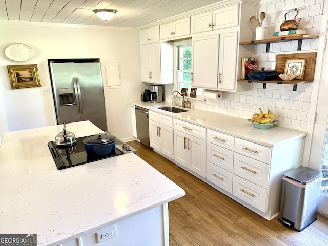 3095 Holbrook Dr SW, Marietta, GA 30060 - kitchen featuring stainless steel appliances, a sink, wood finished floors, white cabinets, and decorative backsplash