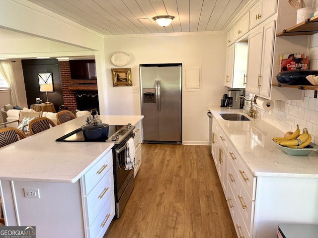 3095 Holbrook Dr SW, Marietta, GA 30060 - kitchen with stainless steel appliances, a sink, white cabinets, open shelves, and crown molding