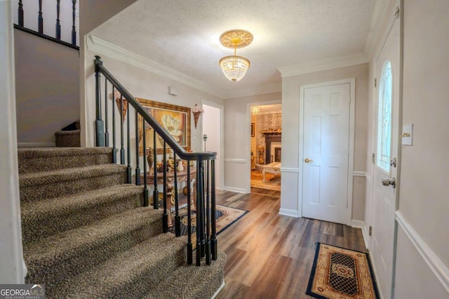 5293 Sandy Shoals Ln, Stone Mountain, GA 30087 - entryway with stairs, wood finished floors, a textured ceiling, ornamental molding, and a chandelier