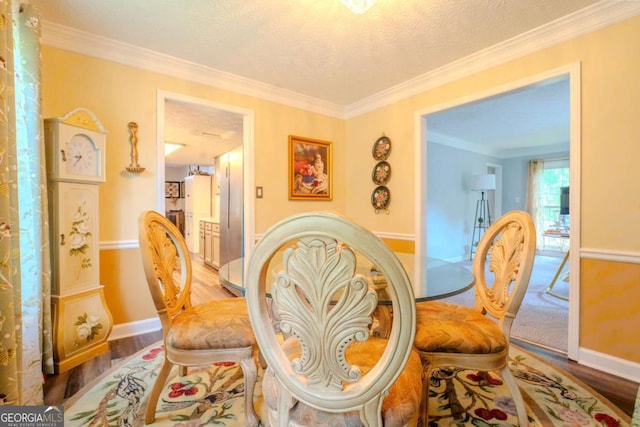 5293 Sandy Shoals Ln, Stone Mountain, GA 30087 - dining space featuring baseboards, wood finished floors, ornamental molding, and a textured ceiling