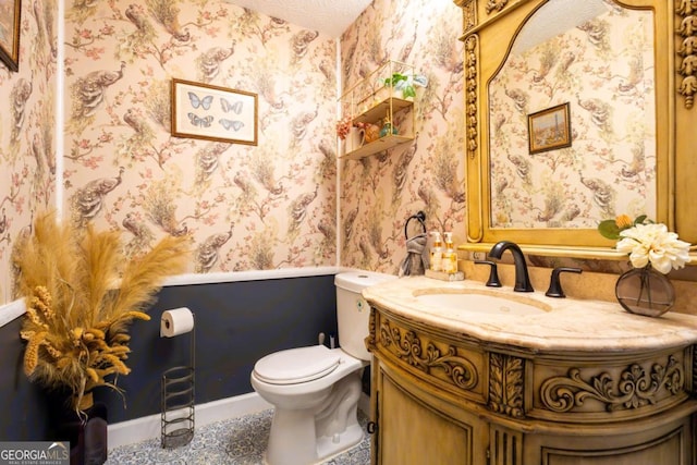 5293 Sandy Shoals Ln, Stone Mountain, GA 30087 - half bath featuring wallpapered walls, vanity, toilet, and baseboards