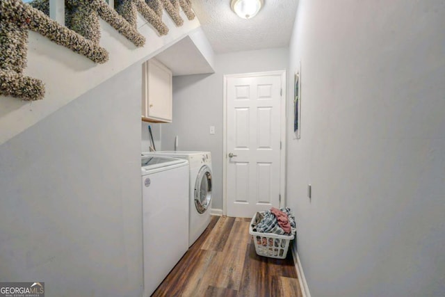 5293 Sandy Shoals Ln, Stone Mountain, GA 30087 - laundry room with washer and dryer, cabinet space, wood finished floors, a textured ceiling, and baseboards