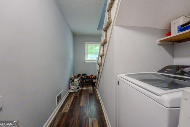 5293 Sandy Shoals Ln, Stone Mountain, GA 30087 - washroom featuring washer / clothes dryer, dark wood-style floors, a textured ceiling, and baseboards