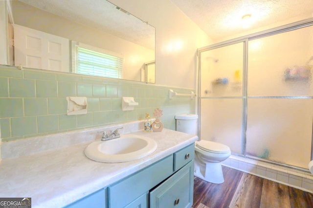 5293 Sandy Shoals Ln, Stone Mountain, GA 30087 - bathroom featuring toilet, a shower stall, vanity, wood finished floors, and a textured ceiling