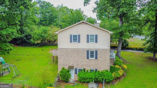 5293 Sandy Shoals Ln, Stone Mountain, GA 30087 - view of property exterior with brick siding, a chimney, and a lawn
