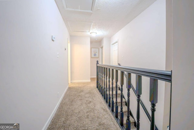 5293 Sandy Shoals Ln, Stone Mountain, GA 30087 - corridor featuring a textured ceiling, carpet flooring, and baseboards