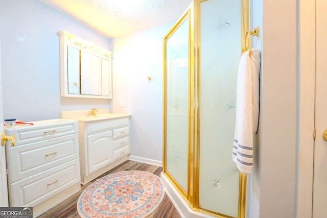5293 Sandy Shoals Ln, Stone Mountain, GA 30087 - full bathroom with vanity, a stall shower, wood finished floors, and a textured ceiling
