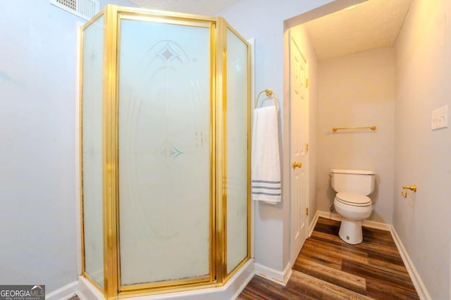 5293 Sandy Shoals Ln, Stone Mountain, GA 30087 - full bath featuring wood finished floors, toilet, a shower stall, and baseboards