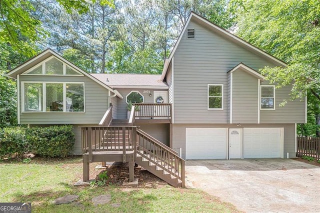view of front of home with an attached garage, stairs, and concrete driveway