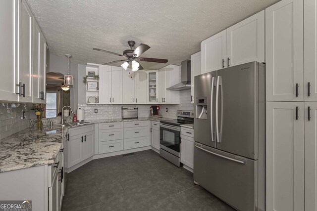 9001 E Carroll Rd, Winston, GA 30187 - kitchen featuring stainless steel appliances, wall chimney range hood, a sink, ceiling fan, and decorative backsplash