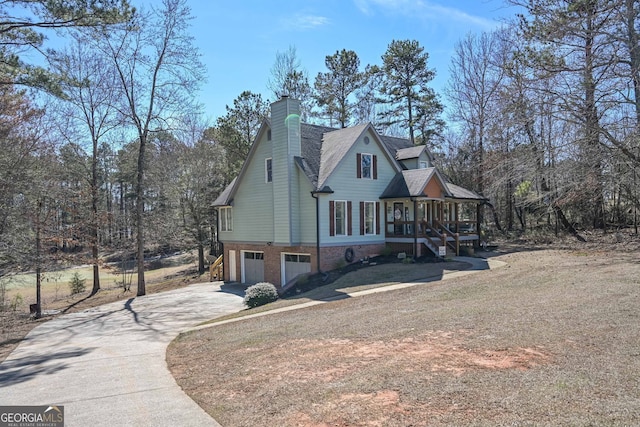 9001 E Carroll Rd, Winston, GA 30187 - view of side of property featuring a garage, concrete driveway, stairs, a chimney, and covered porch
