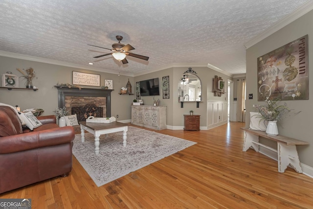 9001 E Carroll Rd, Winston, GA 30187 - living area featuring ceiling fan, wood finished floors, a textured ceiling, a fireplace, and baseboards