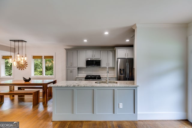 921 Oak Dr, Woodstock, GA 30189 - kitchen with stainless steel appliances, a sink, gray cabinetry, tasteful backsplash, and light stone counters