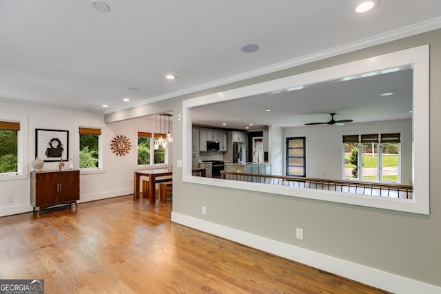 921 Oak Dr, Woodstock, GA 30189 - living room with ornamental molding, healthy amount of natural light, baseboards, a ceiling fan, and wood finished floors