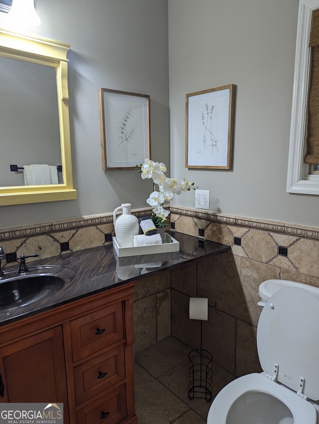 921 Oak Dr, Woodstock, GA 30189 - half bath with vanity, toilet, tile walls, and a wainscoted wall