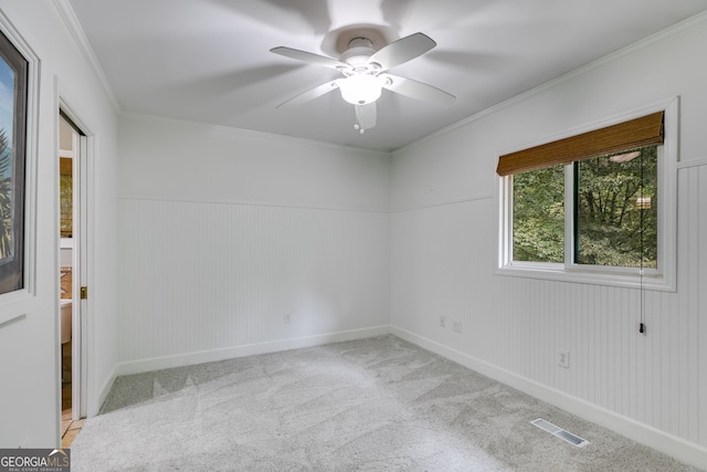 921 Oak Dr, Woodstock, GA 30189 - spare room with a ceiling fan, carpet floors, ornamental molding, baseboards, and a wainscoted wall