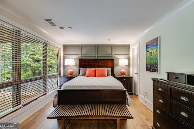 921 Oak Dr, Woodstock, GA 30189 - bedroom with crown molding, light wood-style floors, and baseboards
