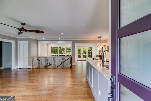 921 Oak Dr, Woodstock, GA 30189 - kitchen with light stone countertops, crown molding, wood finished floors, a ceiling fan, and a chandelier