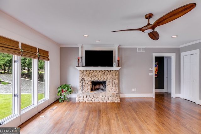 921 Oak Dr, Woodstock, GA 30189 - unfurnished living room with ceiling fan, crown molding, wood finished floors, a stone fireplace, and recessed lighting