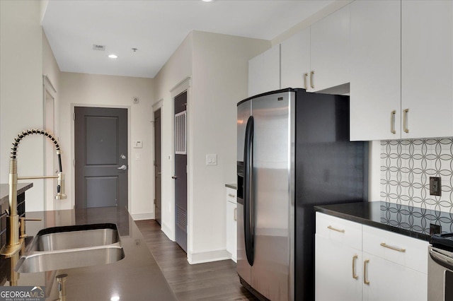 44 Peachtree Pl NW Unit 2024, Atlanta, GA 30309 - kitchen with stainless steel refrigerator with ice dispenser, a sink, dark wood-type flooring, white cabinets, and dark countertops