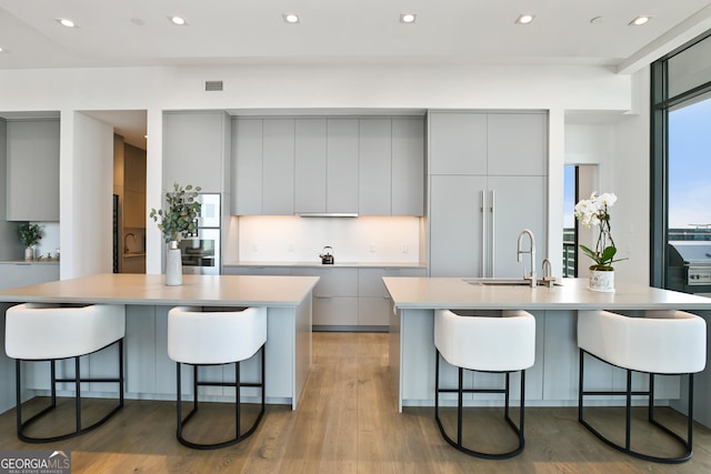 3107 Peachtree Rd NE Unit 2003Aka Ph3, Atlanta, GA 30305 - kitchen with gray cabinetry, an island with sink, modern cabinets, a sink, and recessed lighting