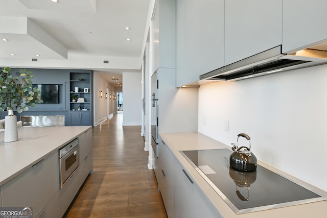 3107 Peachtree Rd NE Unit 2003Aka Ph3, Atlanta, GA 30305 - kitchen with modern cabinets, dark wood-style flooring, black electric cooktop, recessed lighting, and light countertops