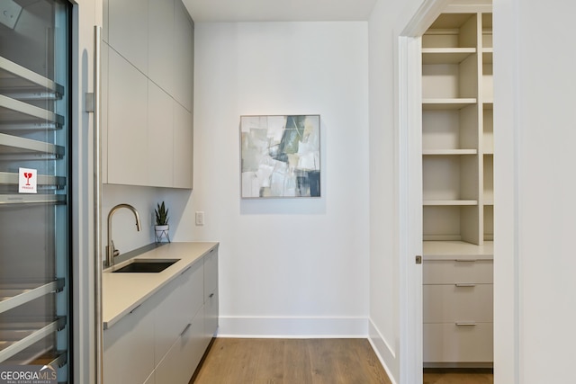 3107 Peachtree Rd NE Unit 2003Aka Ph3, Atlanta, GA 30305 - bar with a sink, dark wood-type flooring, baseboards, and stainless steel refrigerator