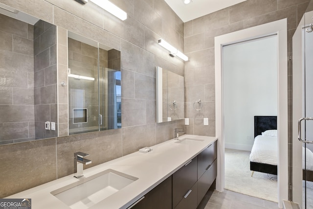 3107 Peachtree Rd NE Unit 2003Aka Ph3, Atlanta, GA 30305 - ensuite bathroom featuring tile walls, double vanity, tile patterned flooring, tasteful backsplash, and a shower with door
