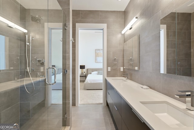3107 Peachtree Rd NE Unit 2003Aka Ph3, Atlanta, GA 30305 - bathroom with tile walls, double vanity, a shower stall, ensuite bath, and tile patterned floors