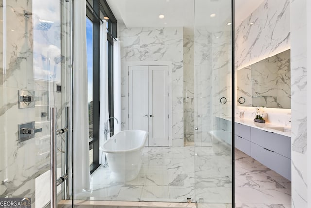 3107 Peachtree Rd NE Unit 2003Aka Ph3, Atlanta, GA 30305 - bathroom featuring stone wall, marble tiled flooring, a marble finish shower, a freestanding bath, and recessed lighting