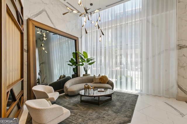 3107 Peachtree Rd NE Unit 2003Aka Ph3, Atlanta, GA 30305 - living area featuring marble tiled flooring, a chandelier, and healthy amount of natural light